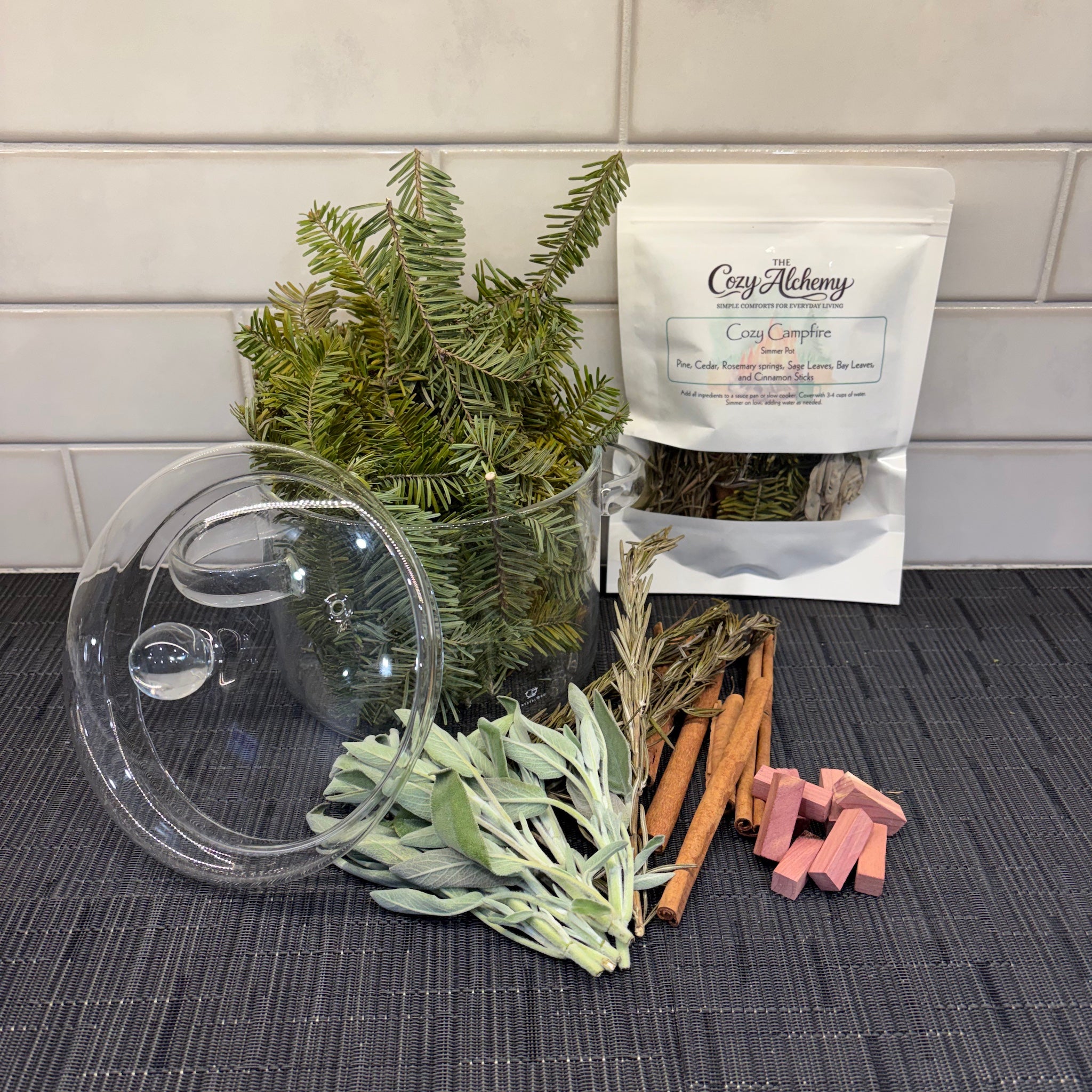 Cozy Campfire simmer pot with pine sprigs, rosemary, sage, and cinnamon — The Cozy Alchemy